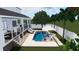 Backyard oasis featuring a stunning pool, spa, patio furniture, and lush landscaping at 4224 W Corona St, Tampa, FL 33629