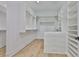 Custom walk-in closet with built-in shelving and storage drawers at 4224 W Corona St, Tampa, FL 33629