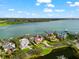 Panoramic aerial view of waterfront homes with private docks and lush landscaping along the scenic bay at 429 St Andrews Dr, Belleair, FL 33756
