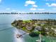 Stunning aerial view of luxury waterfront homes with pools and private docks on a clear, sunny day at 429 St Andrews Dr, Belleair, FL 33756
