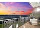 Balcony view featuring ornate railing, outdoor seating and a gorgeous colorful twilight sky at 429 St Andrews Dr, Belleair, FL 33756