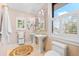 Stylish bathroom with dual sinks, large window, and decorative accents at 429 St Andrews Dr, Belleair, FL 33756