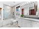 Light filled bathroom with shower, tub, and vanity with marble countertop at 429 St Andrews Dr, Belleair, FL 33756