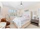 Charming bedroom with large window, ceiling fan, and decorative accents at 429 St Andrews Dr, Belleair, FL 33756