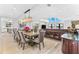 Spacious dining room features a large table, chandelier, and wine storage at 429 St Andrews Dr, Belleair, FL 33756