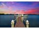 Private dock extending into the water, offering picturesque sunset views and boat access at 429 St Andrews Dr, Belleair, FL 33756