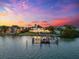 A waterfront home with a private dock sits along a serene body of water at 429 St Andrews Dr, Belleair, FL 33756