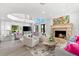 Inviting living room boasts a cozy fireplace and an open view to the gourmet kitchen at 429 St Andrews Dr, Belleair, FL 33756