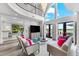 Bright living room with large windows and doors leading to outdoor space and a view at 429 St Andrews Dr, Belleair, FL 33756