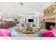 Open living area featuring fireplace, comfortable seating and seamless transition to the kitchen and dining areas at 429 St Andrews Dr, Belleair, FL 33756