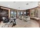 This spacious office has built-in bookshelves, large windows, neutral paint, and a unique desk at 429 St Andrews Dr, Belleair, FL 33756
