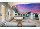 Inviting outdoor living space with a fire pit and seating area overlooking the water at 429 St Andrews Dr, Belleair, FL 33756