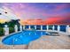 Stunning pool with a built-in hot tub and manicured landscaping overlooking the water at 429 St Andrews Dr, Belleair, FL 33756