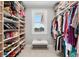 Spacious walk-in closet with custom shelving and a window for natural light at 429 St Andrews Dr, Belleair, FL 33756