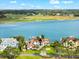 Beautiful waterfront home featuring lush landscaping, a boat dock, and stunning views of the bay and golf course at 429 St Andrews Dr, Belleair, FL 33756