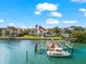 Expansive waterfront home featuring a private boat dock and stunning water views on a sunny day at 429 St Andrews Dr, Belleair, FL 33756