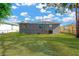 Spacious backyard with lush green grass and a well-maintained exterior at 4304 W Arch St, Tampa, FL 33607