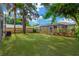 Expansive backyard with lush grass, trees and partial fence at 4304 W Arch St, Tampa, FL 33607