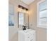 Stylish bathroom featuring a modern vanity, a sleek mirror, and updated lighting at 4304 W Arch St, Tampa, FL 33607