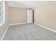 A serene bedroom features neutral walls, gray carpet and a bright window at 4304 W Arch St, Tampa, FL 33607