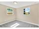 Bright bedroom with neutral walls, gray carpet, and dual windows at 4304 W Arch St, Tampa, FL 33607