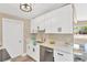 Bright kitchen boasts white cabinets, stainless steel appliances, and modern hardware at 4304 W Arch St, Tampa, FL 33607