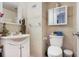Tiled bathroom featuring a vanity with storage and a mirrored medicine cabinet at 4306 La Mora Ct, Tampa, FL 33611
