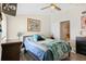 Comfortable bedroom with a plush bed, dresser, and artistic wall decorations at 4306 La Mora Ct, Tampa, FL 33611