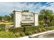 Landscaped entrance to Tampa Villas South, a private community, beneath a partly cloudy sky at 4306 La Mora Ct, Tampa, FL 33611