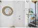 Bright entryway featuring a white door, round mirror, and decorative plant at 4306 La Mora Ct, Tampa, FL 33611