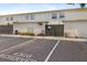 Beige condo exterior with reserved parking, fenced entry, and blooming flowers at 4306 La Mora Ct, Tampa, FL 33611