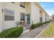 Charming front porch with seating, landscaping, and a blue front door at 4306 La Mora Ct, Tampa, FL 33611
