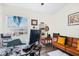 The bright home office includes a leather couch, desk and shelves in a modern setting at 4306 La Mora Ct, Tampa, FL 33611
