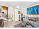 Bright living room with a staircase, gray sofa, and vibrant artwork at 4306 La Mora Ct, Tampa, FL 33611