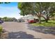 Exterior view of condo parking lot with mature shade trees and ample parking at 4306 La Mora Ct, Tampa, FL 33611