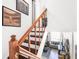 Wooden staircase featuring baseball memorabilia, hardwood steps, and a view of the living room at 4306 La Mora Ct, Tampa, FL 33611