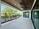 A spacious covered balcony with modern railings, ceiling fans and wood-look ceiling is great for relaxing and enjoying the view at 500 E Davis Blvd, Tampa, FL 33606