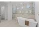 Luxurious bathroom showcasing a soaking tub, frameless shower, and contemporary tile at 500 E Davis Blvd, Tampa, FL 33606