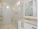 Bright bathroom with double vanity, modern fixtures, and a glass-enclosed shower with gold accents at 500 E Davis Blvd, Tampa, FL 33606