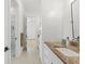 Bathroom features a long vanity with beautiful stone countertops, and an open doorway to a tiled shower at 500 E Davis Blvd, Tampa, FL 33606