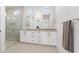 Modern bathroom featuring double vanity, a glass enclosed shower with gold fixtures and ample cabinet space at 500 E Davis Blvd, Tampa, FL 33606