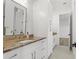 A bathroom features a long vanity with beautiful stone countertops, storage cabinets, and modern fixtures at 500 E Davis Blvd, Tampa, FL 33606