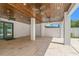 Covered patio with stained wood plank ceiling, tile flooring, and views to the backyard at 500 E Davis Blvd, Tampa, FL 33606
