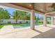 Covered patio with wood plank ceiling, ceiling fans, tile flooring, and views of the backyard swimming pool at 500 E Davis Blvd, Tampa, FL 33606