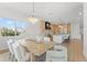 Bright dining room features a modern light fixture, light wood table, and lots of seating in an open concept floor plan at 500 E Davis Blvd, Tampa, FL 33606