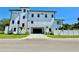 Modern home boasts a sleek white facade, black trim, and an attached garage at 500 E Davis Blvd, Tampa, FL 33606
