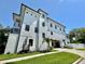 Modern home with a sleek design, manicured lawn, and an attached garage at 500 E Davis Blvd, Tampa, FL 33606