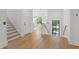 Bright foyer with hardwood floors, staircase, and a view into the living room at 500 E Davis Blvd, Tampa, FL 33606