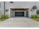 Modern home featuring garage with dark wood ceiling and exterior lights at 500 E Davis Blvd, Tampa, FL 33606
