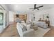 Spacious open-concept living room with modern furnishings and beautiful flooring, seamlessly flowing into the eat-in kitchen at 500 E Davis Blvd, Tampa, FL 33606